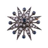 A late Victorian diamond and sapphire star brooch, circa 1890, the central circular cut sapphire