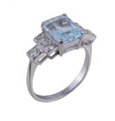 A diamond and aquamarine ring , the central step cut aquamarine with canted corners between two