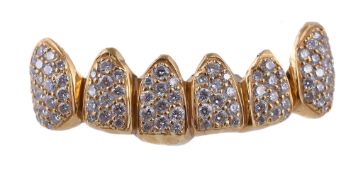 A diamond set dental grill, the gold coloured setting with pave set diamond teeth, approximately 1.