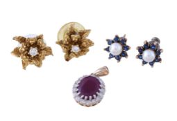 A pair of 18 carat gold diamond flower head ear studs , each centred with a brilliant cut diamond,
