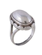 A silver Georg Jensen No 19 dress ring , with domed polished centre and lobed surround, stamped