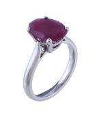 An 18 carat gold ruby ring , the oval cut ruby within a four claw setting, finger size P 1/2