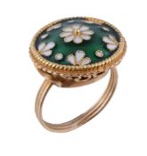 A white and green enamelled dress ring, the circular panel with white flower heads upon green