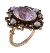 A mid 19th century pink topaz and half pearl ring, circa 1840, the central oval cut pink topaz in a