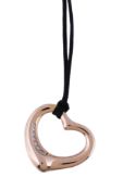 An 18 carat gold and diamond open heart pendant by Elsa Peretti for Tiffany & Co., set with