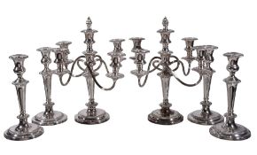 A pair of electro-plated four light candelabra and four candlesticks, stamped Garrard & Co. Ltd.,