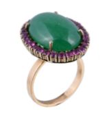 A stained agate and ruby ring, the oval cabochon stained green agate claw set within a surround of
