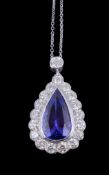 A tanzanite and diamond pendant, the pear cut tanzanite estimated to weigh 5.40 carats within a