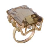 A smoky quartz and diamond dress ring, the rectangular cut smoky quartz, claw set in a brilliant