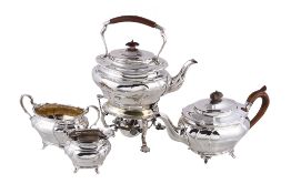 An Edwardian silver three piece oval baluster tea service by Goldsmiths & Silversmiths Co. Ltd.,