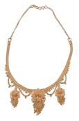 An Indian gold coloured necklace , the beaded necklace with three graduated gold coloured flower