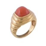 Ω A coral dress ring, the sugarloaf cabochon coral within a polished reeded surround, finger size N