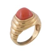 Ω A coral dress ring, the sugarloaf cabochon coral within a polished reeded surround, finger size N