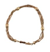 A gold bracelet, composed of woven gold strands with polished bead spacers, stamped 750 and MSF,