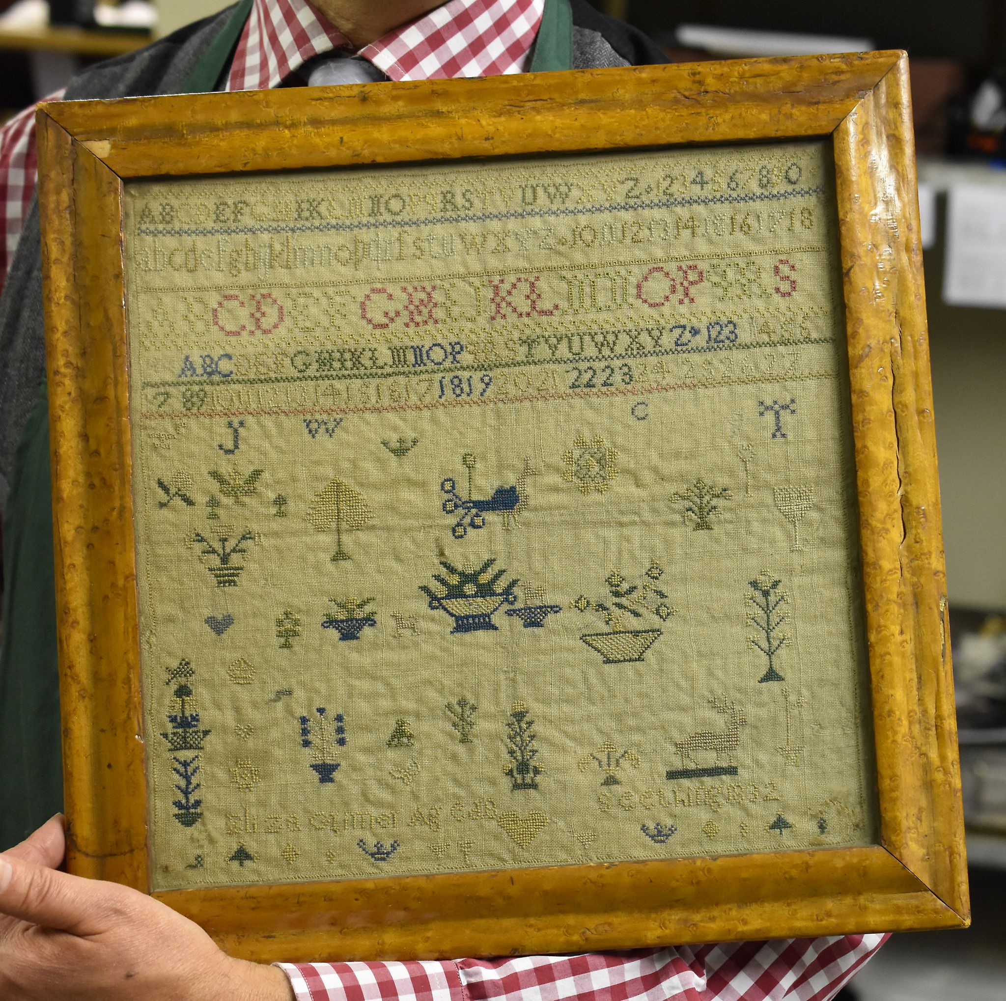 A 19th century sampler, indistinctly named and dated 1832, 30cm x 31cm, framed and glazed