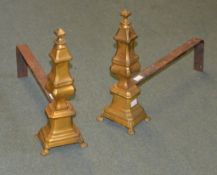 A pair of Continental brass fire dogs