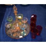 A coloured glass liqueur set, and five cranberry tinted glass beakers