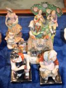A Staffordshire pottery group of musicians, a pair of figures of the Cobbler and His Wife, and other