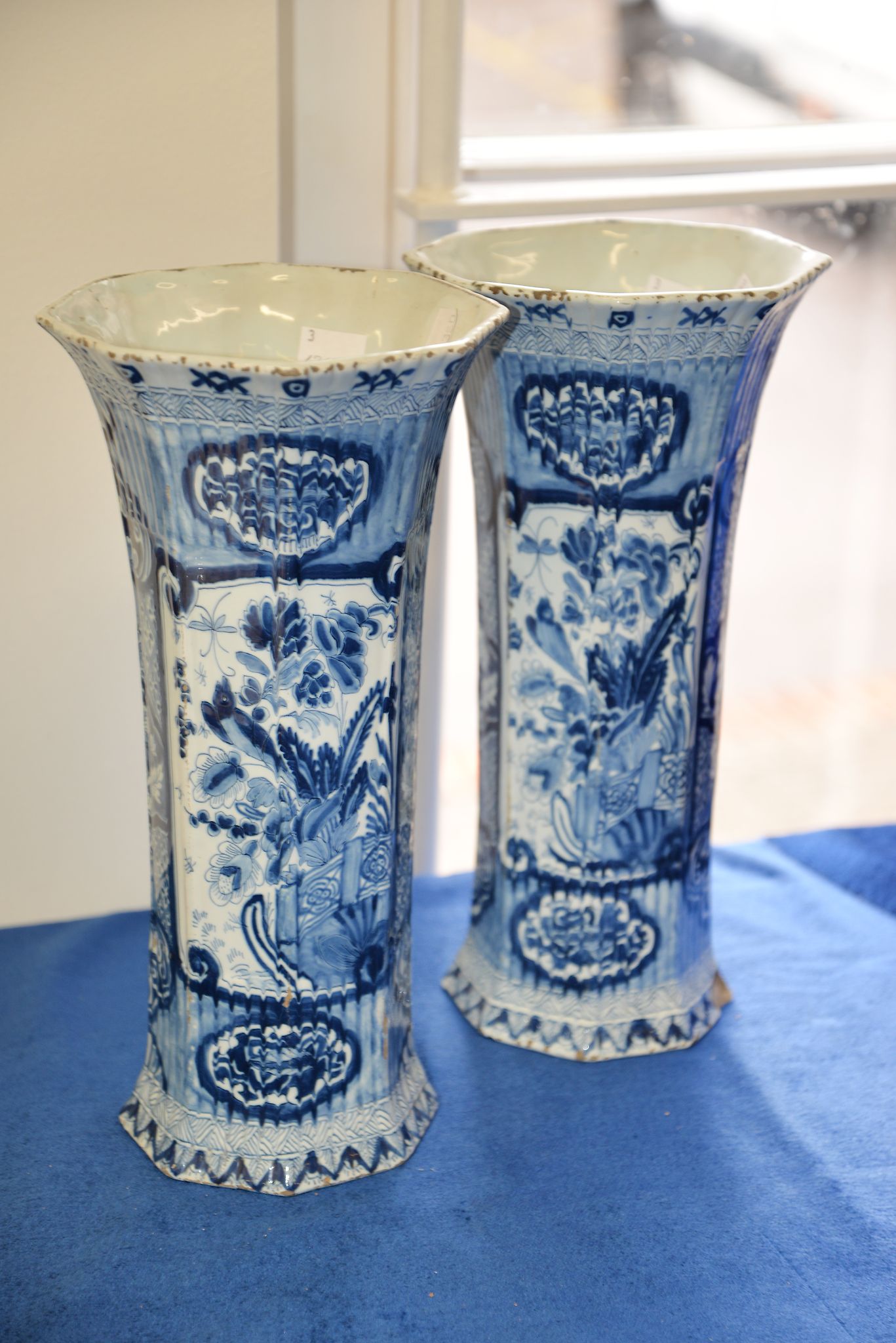 A pair of Delft blue and white vases, of octagonal section decorated with floral reserves. 33cm high