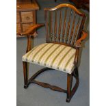 A stained beech spindle back armchair, 83cm high