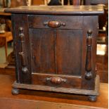 An oak spice cupboard, the fielded panel door enclosing an arrangement of drawers, 44cm high, 44.5cm