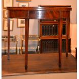 A George III mahogany and crossbanded semi-elliptical card table on square tapering legs with