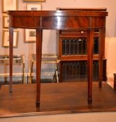 A George III mahogany and crossbanded semi-elliptical card table on square tapering legs with