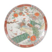 A large Japanese charger, yellow and iron-red, decorated with blossom and peacocks picked out in