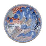 An Arita Porcelain Charger, of dished, circular form, decorated in underglaze blue, enamels and
