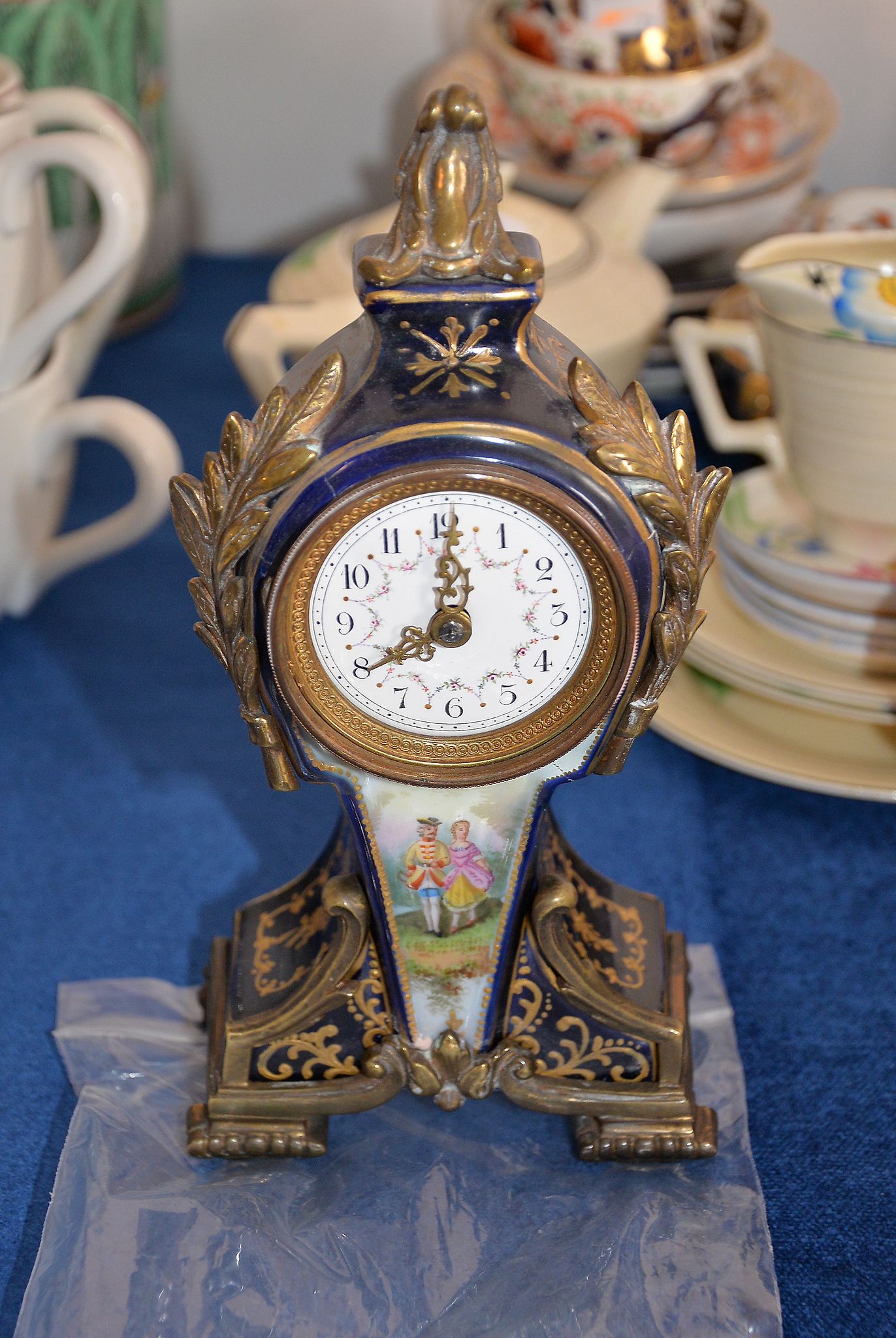 A French porcelain Sevres style and gilt metal mounted mantel timepiece, 22cm high