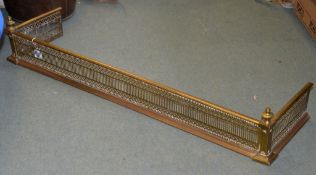 A brass fender, with pierced fretwork decoration, 126cm wide