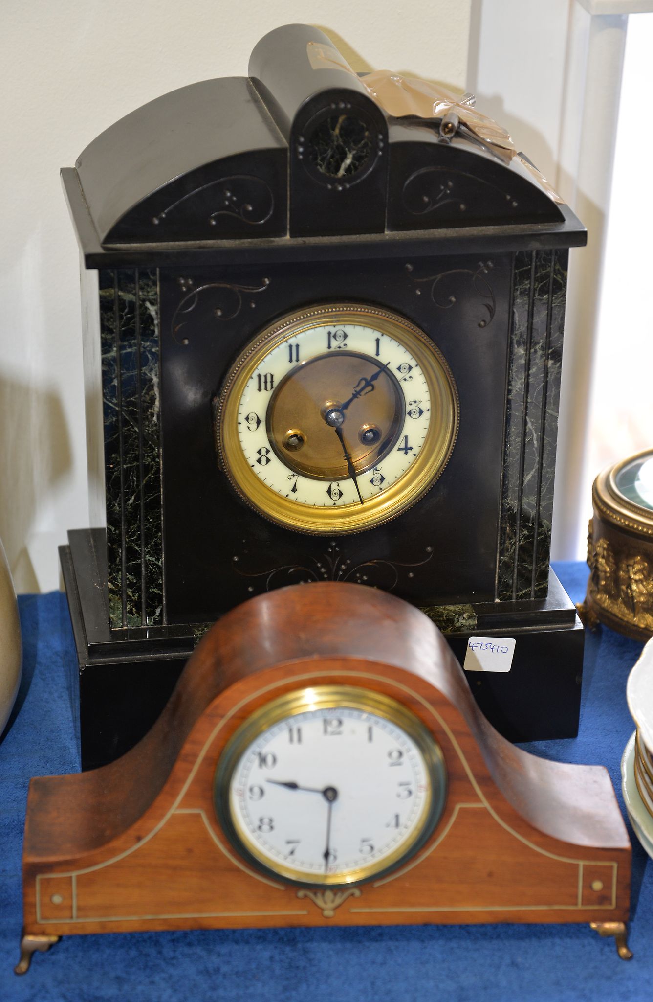 A slate mantel clock, 34cm high; and a mahogany mantel timepiece Provenance: The collection of the