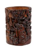 A Chinese bamboo brush vase, carved with a sage and two attendants, 16cm high x 11.8cm diameter
