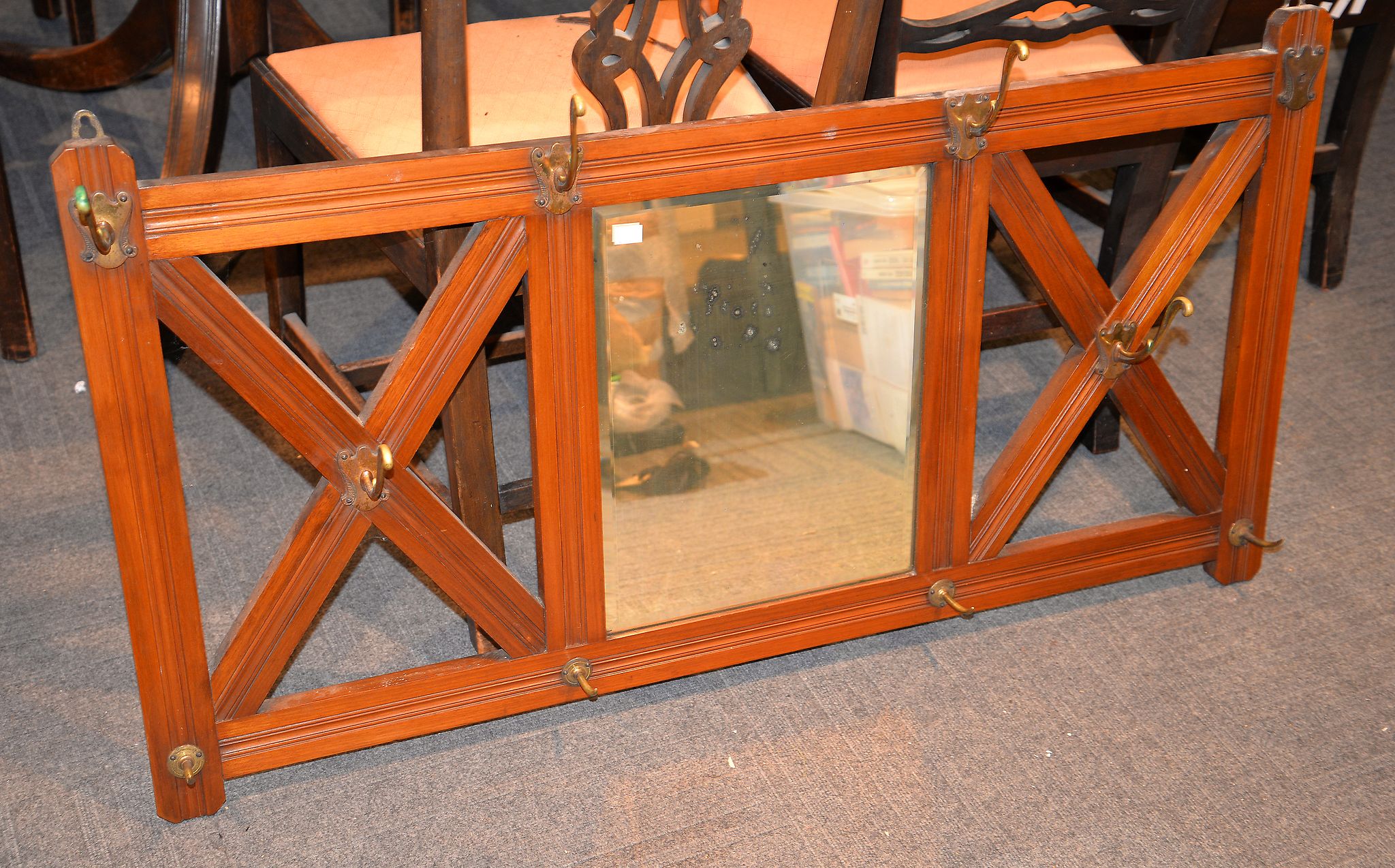 A late 19th century walnut coat rack, with brass hooks and central mirror