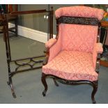 A late Victorian pink upholstered armchair with carved show frame, and a mahogany and glazed fire