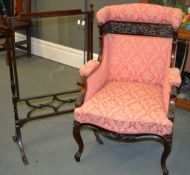 A late Victorian pink upholstered armchair with carved show frame, and a mahogany and glazed fire