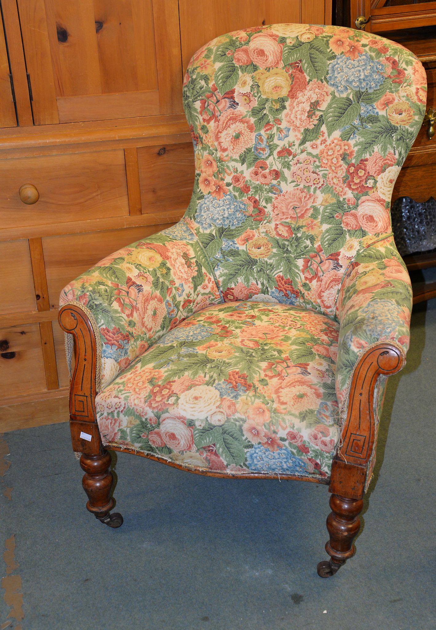 AVictorian carved walnut and upholstered spoonback armchair, and an oatmeal upholstered armchair