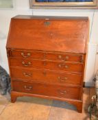 A George III mahogany bureau, late 18th century, the fall enclosing an arrangement of drawers and