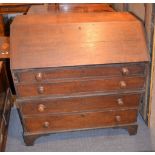 A 19th century oak bureau, with fittings enclosed by a fall, above four long drawers