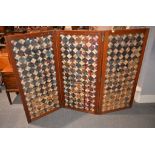 A late Victorian walnut three-fold screen, each panel with woven geometric designs, 123cm high