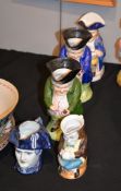 A Delft character jug of "The Tyrant" Bonaparte, two similar Sitzendorf 'snuff taker' Toby jugs, and