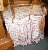 A kidney shaped dressing table covered in floral fabric, 77cm high, 93cm wide