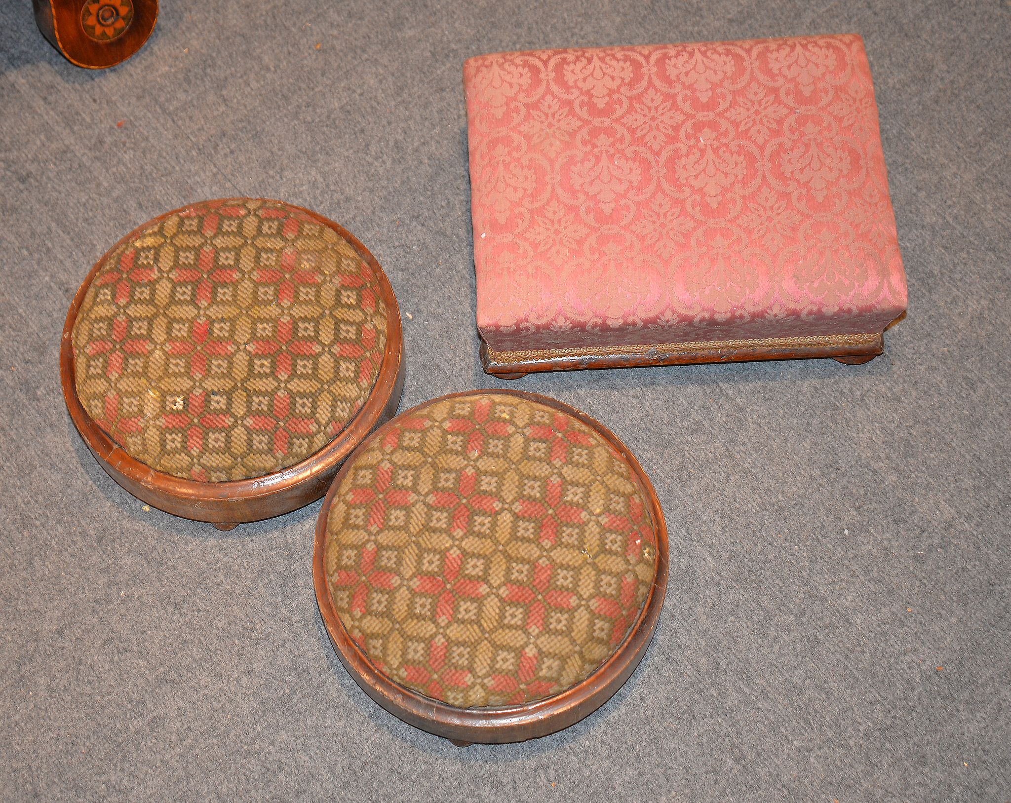 Two Victorian round footstools, with needlework tops, and a rectangular foot stool (3)