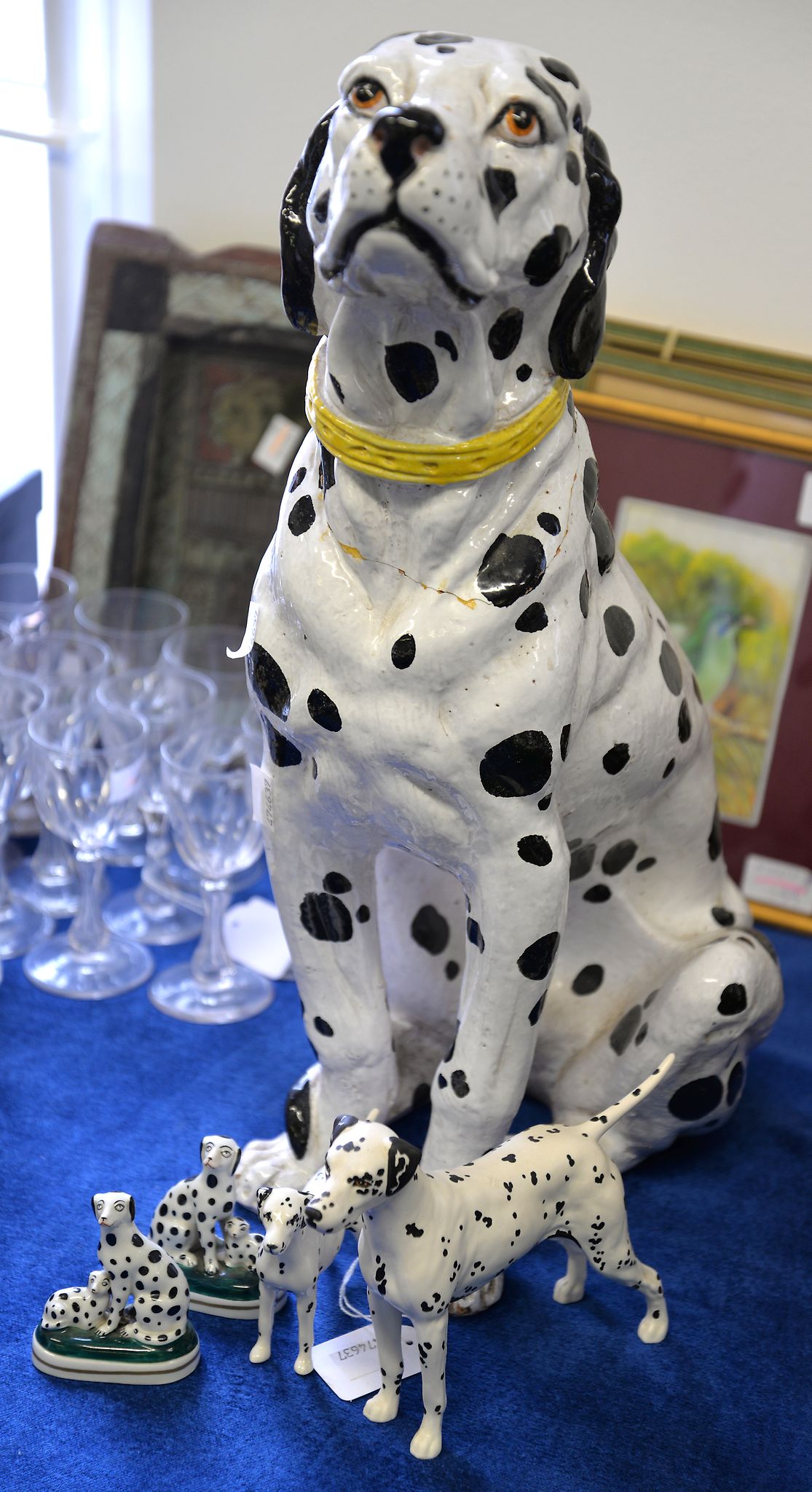 A large pottery model of a Dalmation, a Beswick example, a Staffordshire style pair and one other