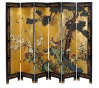 A Chinese polychrome lacquer and parcel gilt six fold screen, 20th century, decorated with a scene