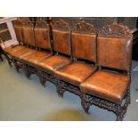 A set of six leather upholstered dining chairs in Carolean style, two similar oak and inlaid