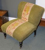 A Victorian ebonised and upholstered low chair, with overstuffed upholstery