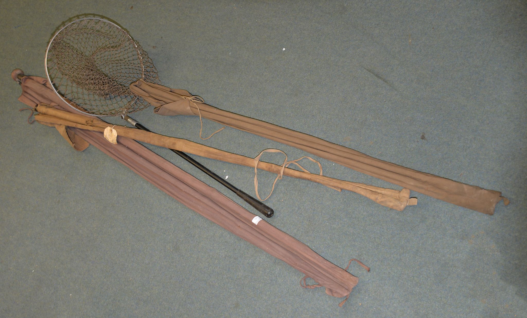 A quantity of various vintage fishing equipment including a split cane fishing rod, a landing net,
