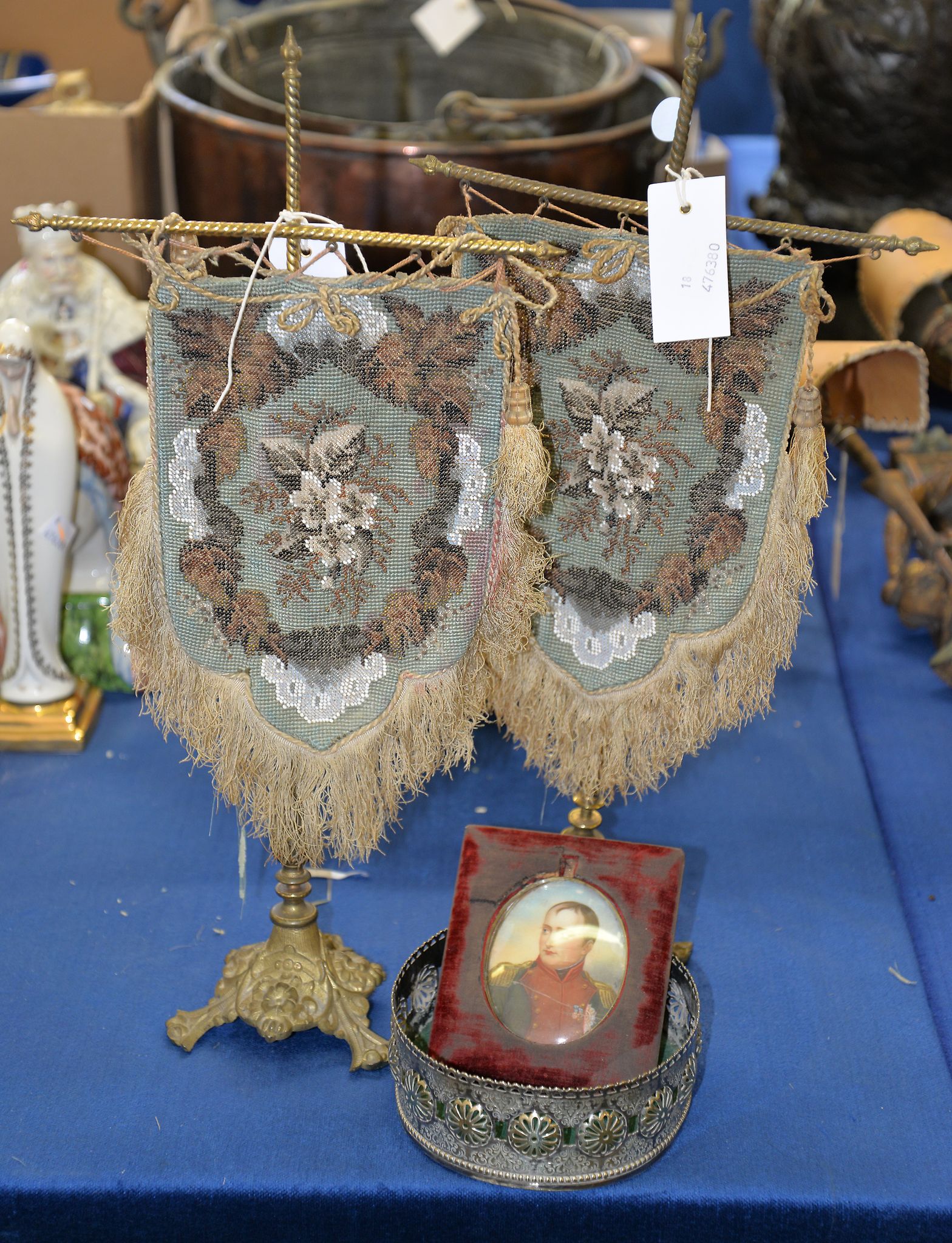 A pair of Early Victorian table screens, a silver plate coaster and a miniature of Napoleon