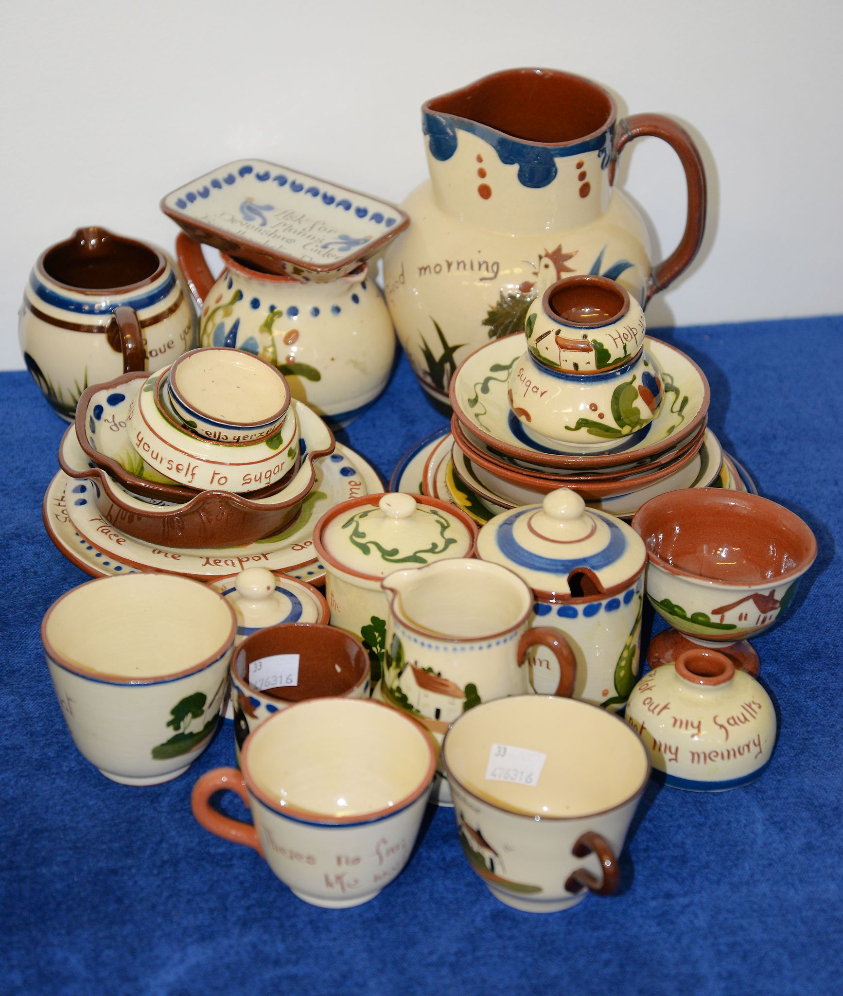 A quantity of Devon pottery mottoware, including Watcombe, and Longpark Torquay examples Provenance: